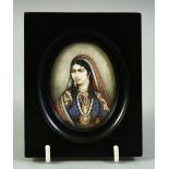 AN INDIAN MINIATURE OVAL PORTRAIT OF A FEMALE FIGURE on ivory, in an ebonised wood frame and glazed,