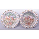 TWO LARGE CHINESE EXPORT PORCELAIN CHARGERS, painted with European scenes depicting figures on