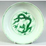 A CHINESE GREEN ENAMELLED PORCELAIN DRAGON DISH, with six character mark to base, 22.5cm diameter.