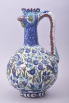 A GOOD IZNIK STYLE GLAZED POTTERY EWER, the spout formed as a cockerel head, the body decorated with