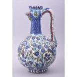 A GOOD IZNIK STYLE GLAZED POTTERY EWER, the spout formed as a cockerel head, the body decorated with