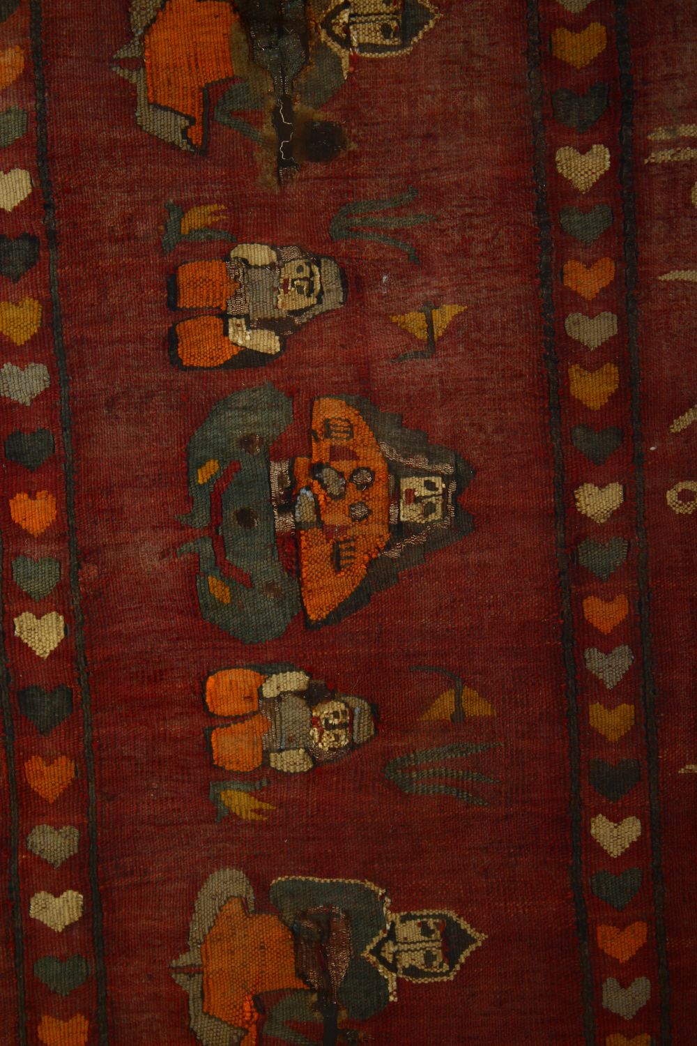 AN ISLAMIC TEXTILE FRAGMENT, the textile embroidered with seated figures and with bands of script, - Image 3 of 4