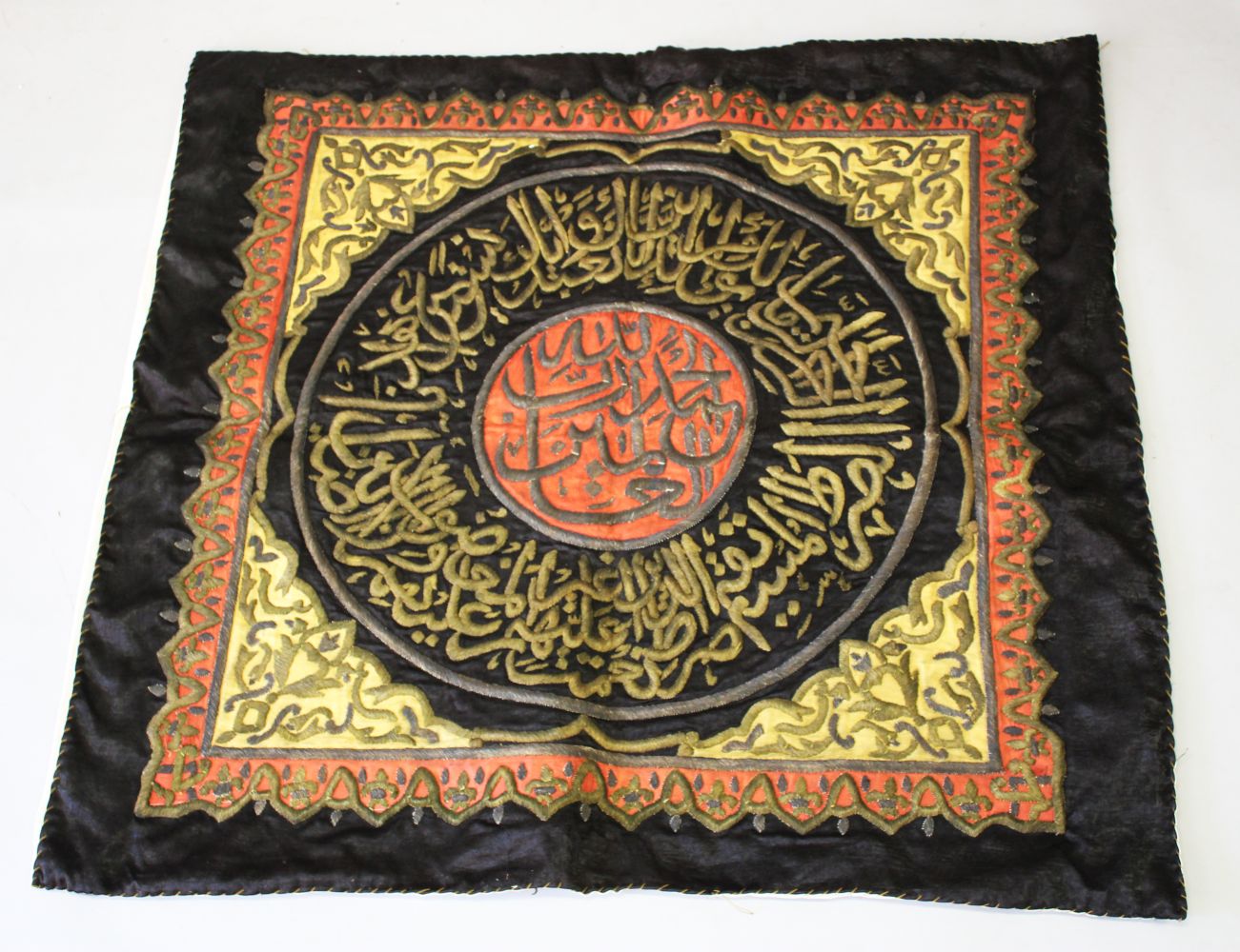 AN ISLAMIC GILT METAL THREADED TEXTILE, the textile with central calligraphy.