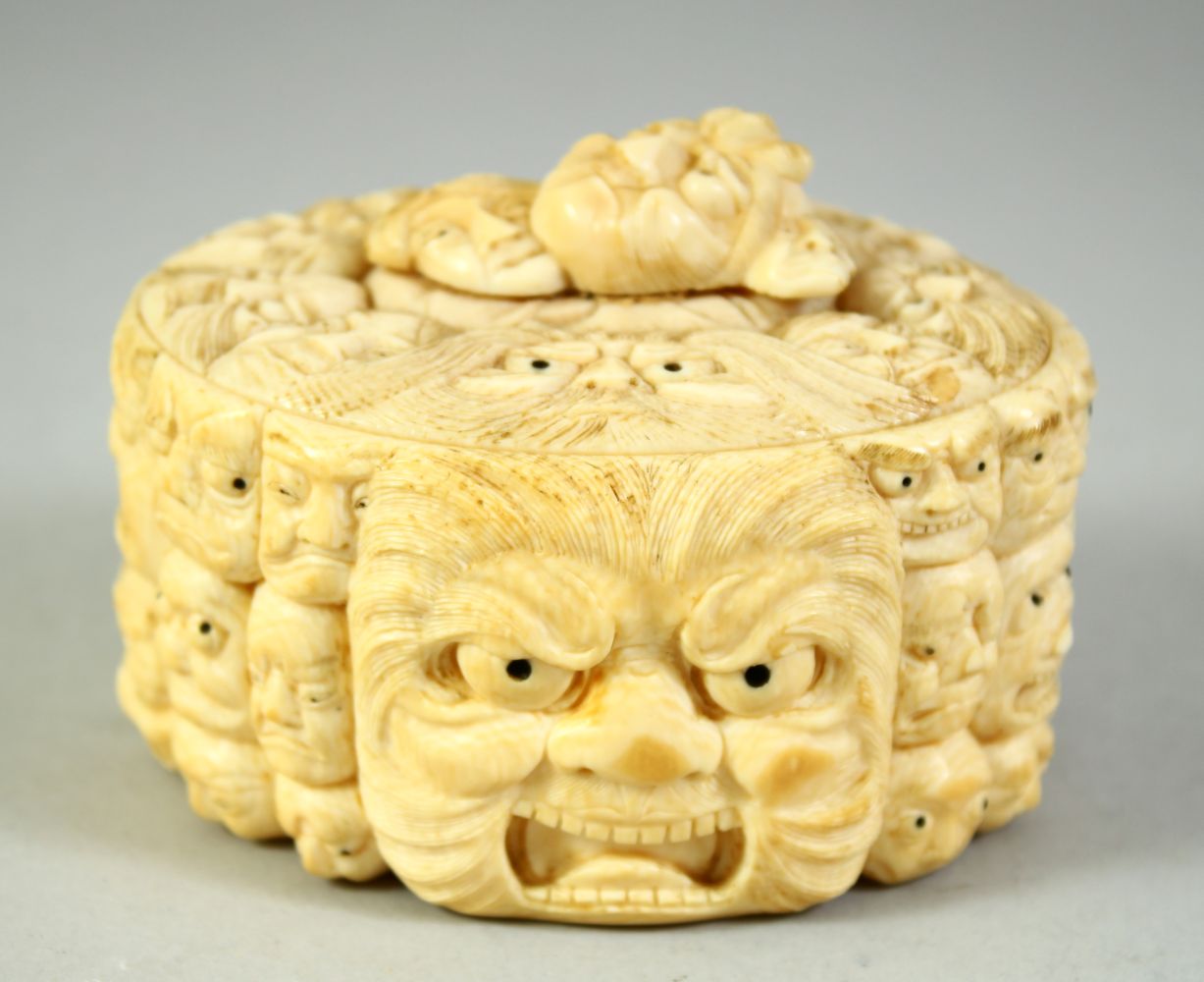 A JAPANESE CARVED IVORY NOH MASK BOX AND COVER, the box carved all over with various theatre masks