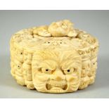 A JAPANESE CARVED IVORY NOH MASK BOX AND COVER, the box carved all over with various theatre masks