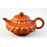 A CHINESE LOTUS FORMED YIXING TEAPOT, the inner lid and base with impressed marks, 16cm from spout