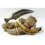 A MIDDLE EASTERN JAMBIYA DAGGER AND BELT, with wooden handle mounted with white metal, the wooden