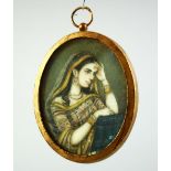 AN INDIAN MINIATURE OVAL PORTRAIT OF A FEMALE FIGURE on ivory, encased within a gilt metal frame and
