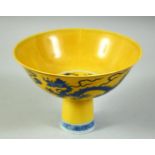 A CHINESE YELLOW GROUND PORCELAIN STEM CUP, the bowl decorated with dragons and the flaming pearl of