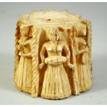 A FINE 18TH CENTURY INDIAN CARVED BONE STAND, depicting female musicians and dancers, 7cm high.