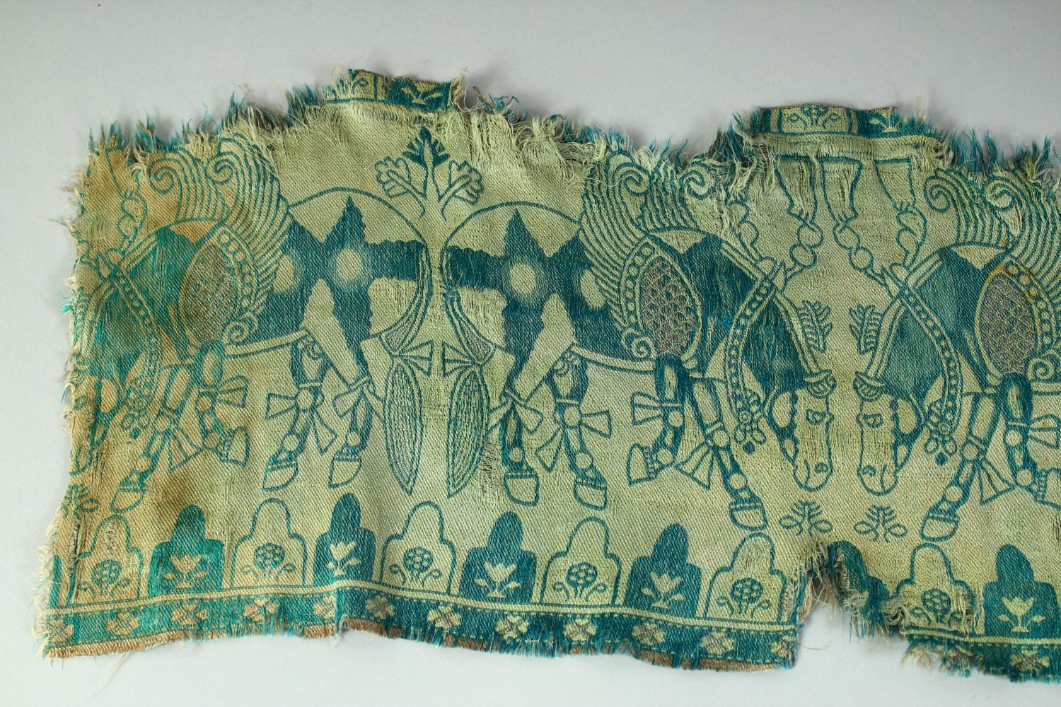 AN ISLAMIC TEXTILE FRAGMENT, embroidered with horses. - Image 2 of 8