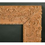 A highly carved 20th Century frame, rebate size 20" x 24".