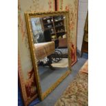 A large modern gilt framed mirror.