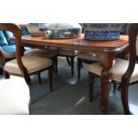A Victorian and later extending mahogany dining table.