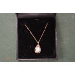 A gold and opal set pendant and chain.