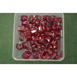 A box of ruby coloured stones.