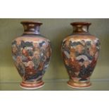 A pair of Satsuma vases decorated with numerous figures.