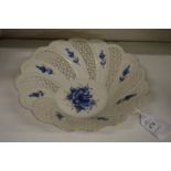 A small porcelain blue and white bowl with pierced decoration.