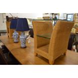 A pair of wicker and glass lamp tables.