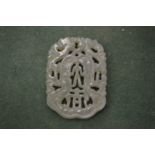 A carved jade amulet.