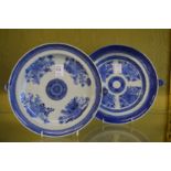 Two blue and white warming dishes.