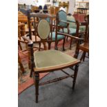 An Edwardian inlaid mahogany small armchair.