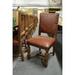 A set of ten oak dining chairs with leather cloth upholstered backs and seats, together with a