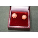 A pair of coral ear studs.