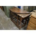 An old oak drop-leaf gate-leg table.