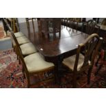 A good Regency mahogany extending dining table with patent ratchet mechanism and two extra leaves.