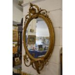 A 19th century decorative gilt framed oval girandole.