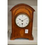 A mahogany mantle clock.
