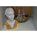 A pottery bust of a young lady and a floral decorated basket.