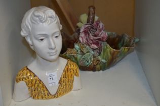 A pottery bust of a young lady and a floral decorated basket.