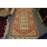 A Persian style beige ground rug.