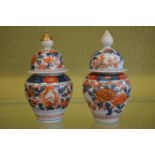 A near pair of small Imari vases and covers.