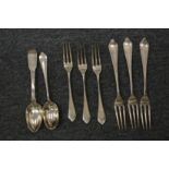 A small group of silver flatware.