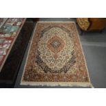 A Persian style rug, beige ground with floral decoration.