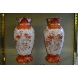 A pair of Kutani vases with unusual lion moulded bases.