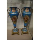 A pair of large decorative continental porcelain and ormolu vases (AF).