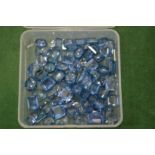 A box of aquamarine coloured stones.