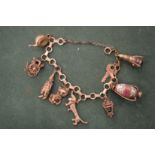 A 9ct gold charm bracelet with numerous charms.