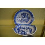 A pair of blue and white leaf shaped dishes.