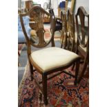 A set of four George III style mahogany shield back dining chairs.