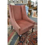 An Edwardian crimson upholstered armchair on cabriole legs.