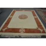 A modern Chinese beige ground carpet with a decorative border 11ft 6ins x 8ft 4ins.