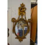A classical style gilt framed oval mirror.