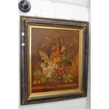 A still life of flowers in a vase on a ledge, oil on canvas in a decorative frame.