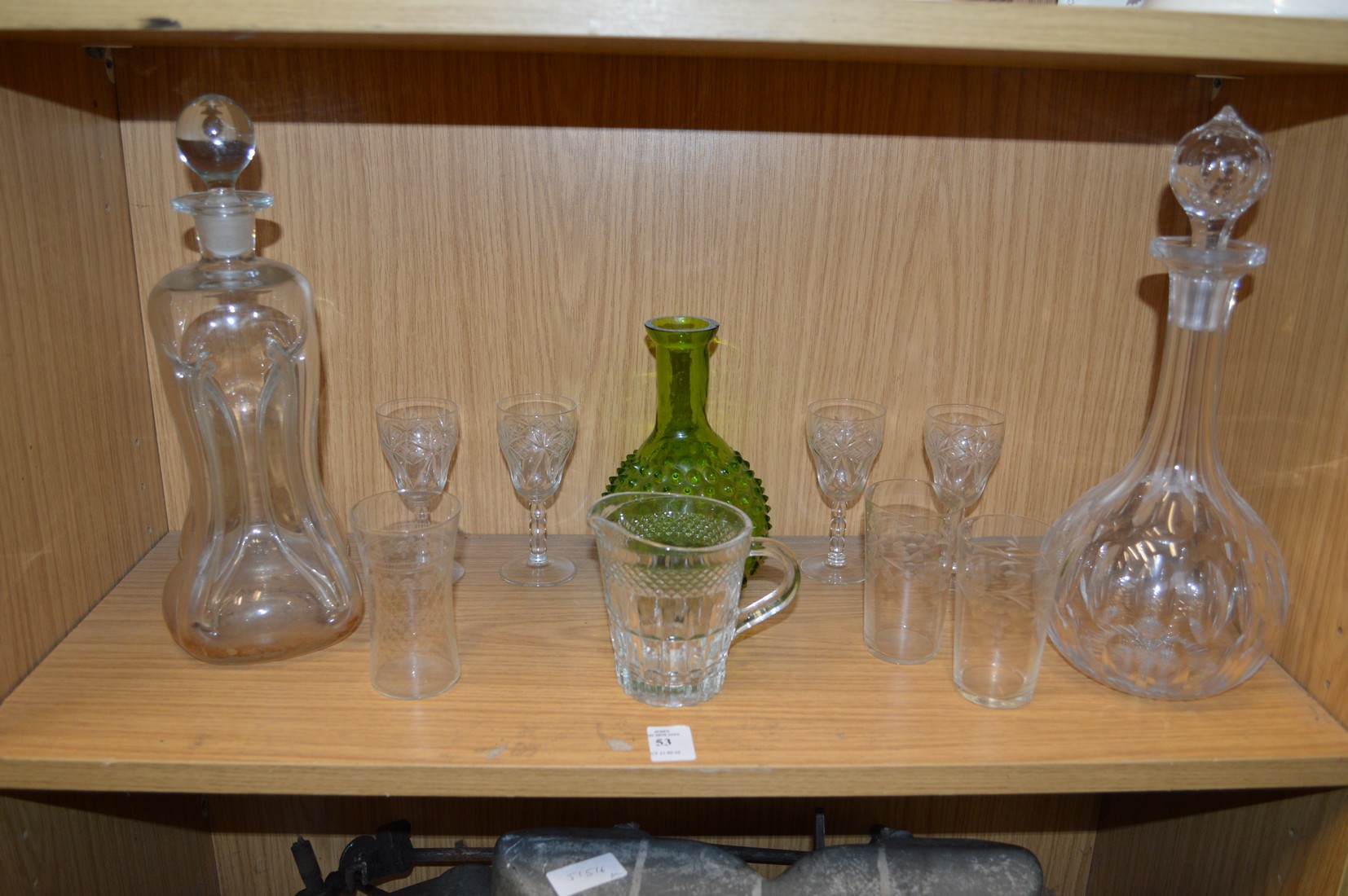 Two cut-glass decanters and other glassware.