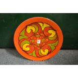 A Poole Pottery Delphis charger, orange ground with stylized floral decoration shape no. 5, 14ins